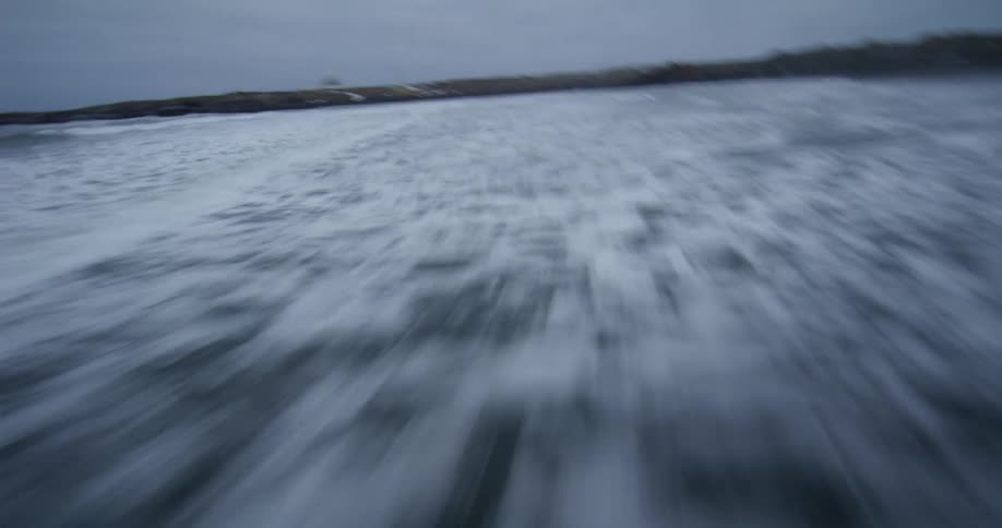 A thrilling first-person view drone flight skimming low and fast over dark, churning ocean waves