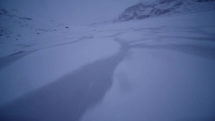 A thrilling first-person perspective ride across a vast, snow-covered frozen lake in the cold winter twilight