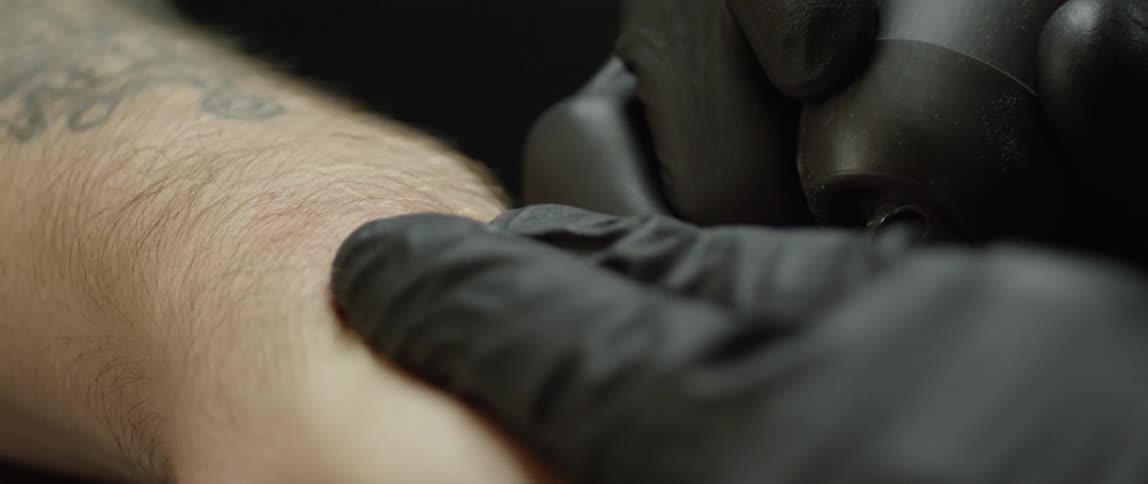 Tattoo artist working on a client