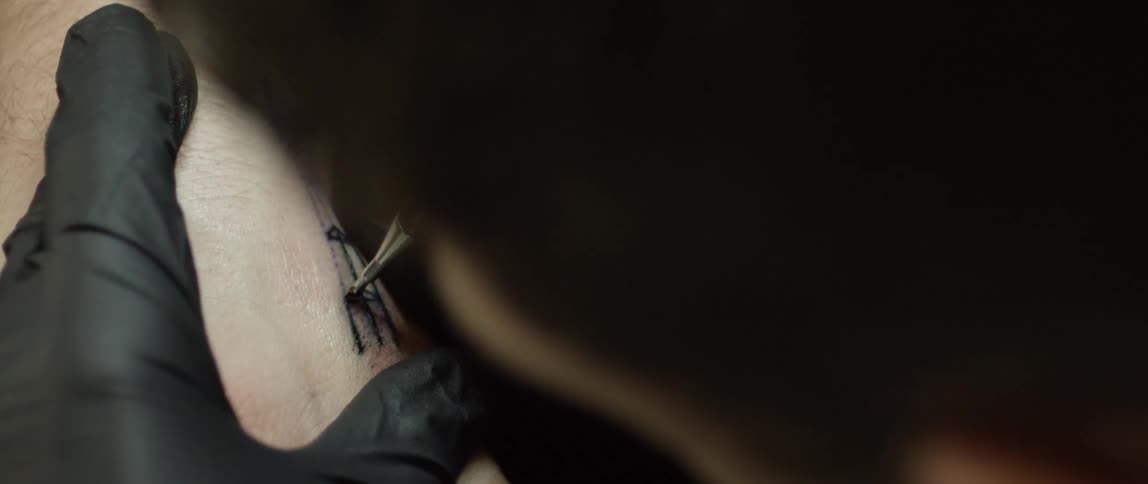 A person gives a tattoo