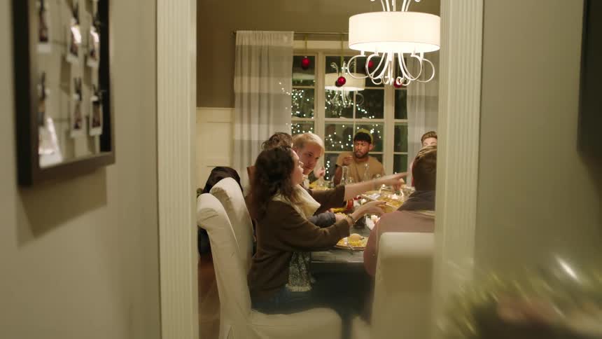 A family sits at a table eating food together