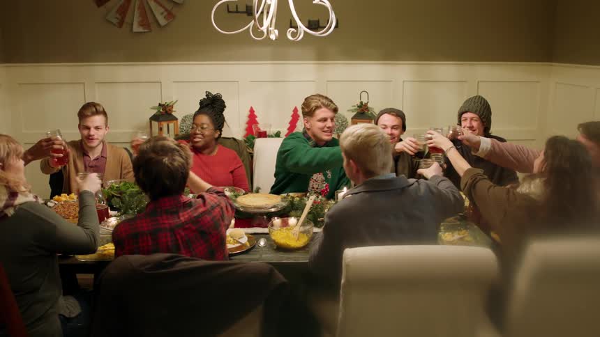 Friends raise a toast and clink glasses at a dinner party