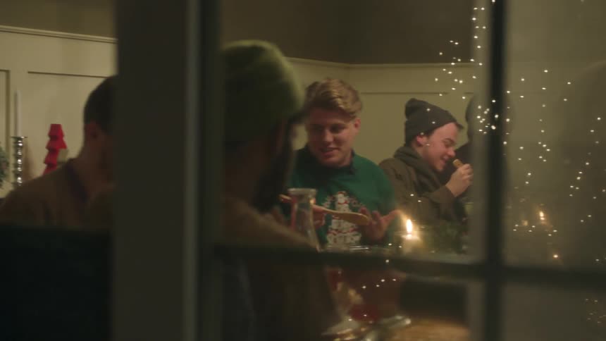 People sit at the dining room table eating and talking