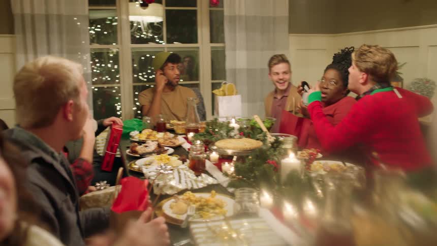 People have fun talking and eating in the dining room