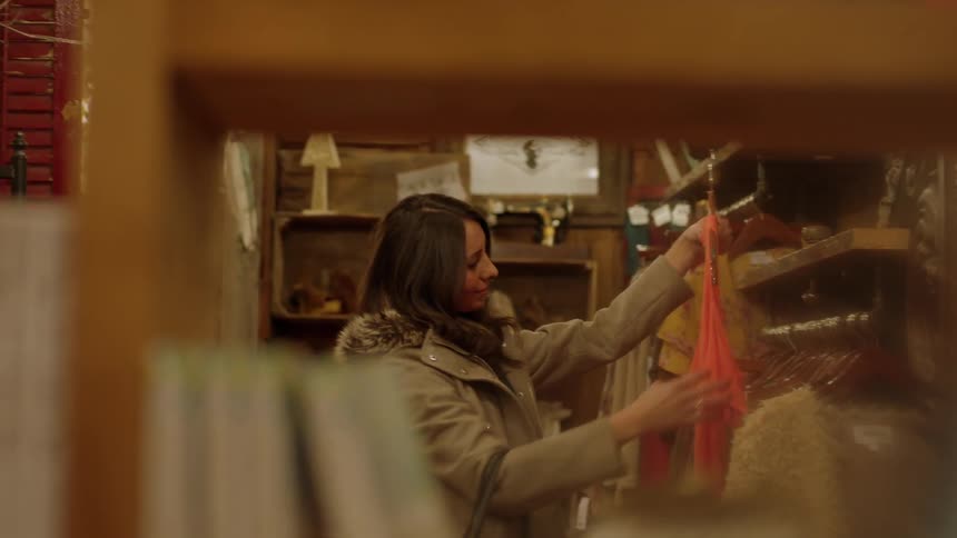 Woman looking at shirt in department store