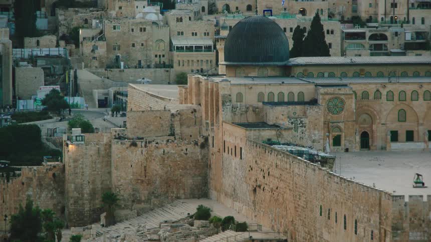 An aerial view tilts up from the ancient ruins at the base of the Temple Mount to reveal the Al-Aqsa Mosque in Jerusalem