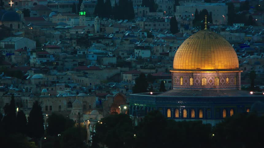 The iconic golden Dome of the Rock is beautifully illuminated against the historic cityscape of Jerusalem at dusk