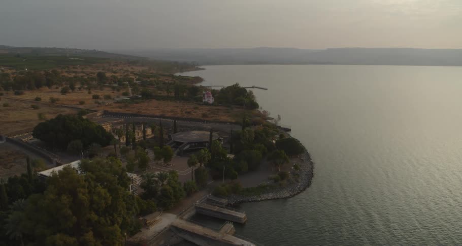 An aerial view rises over the historic site of Capernaum on the shores of the Sea of Galilee at sunrise