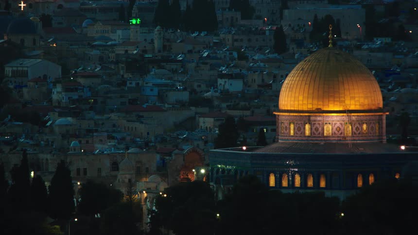 A panning shot reveals the iconic golden Dome of the Rock beautifully illuminated at night, with the Old City of Jerusalem in the background