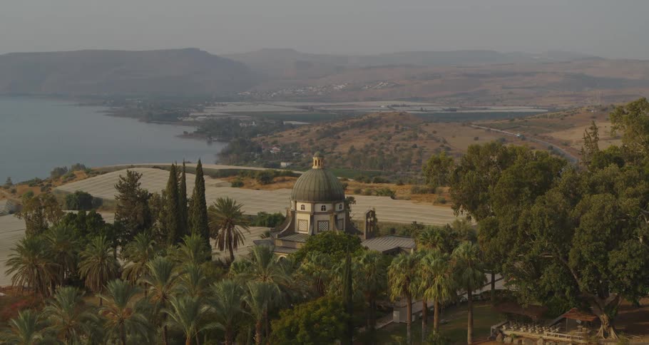 A serene high-angle time-lapse of the Church of the Beatitudes on the shores of the Sea of Galilee in Israel