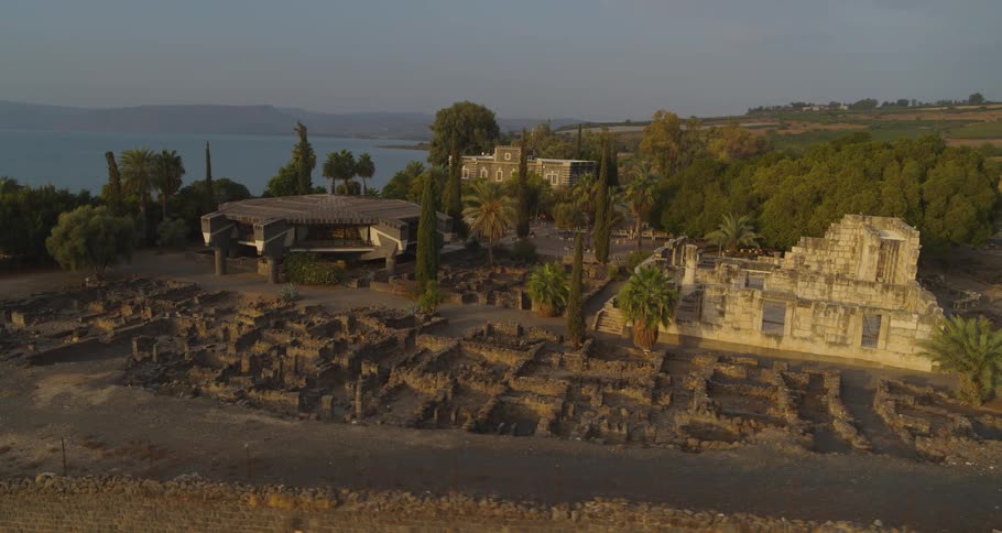 An aerial view reveals the ancient ruins of Capernaum on the shore of the Sea of Galilee in Israel at sunrise