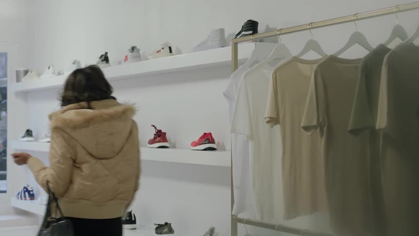 Woman looking at shoes in department store during the day