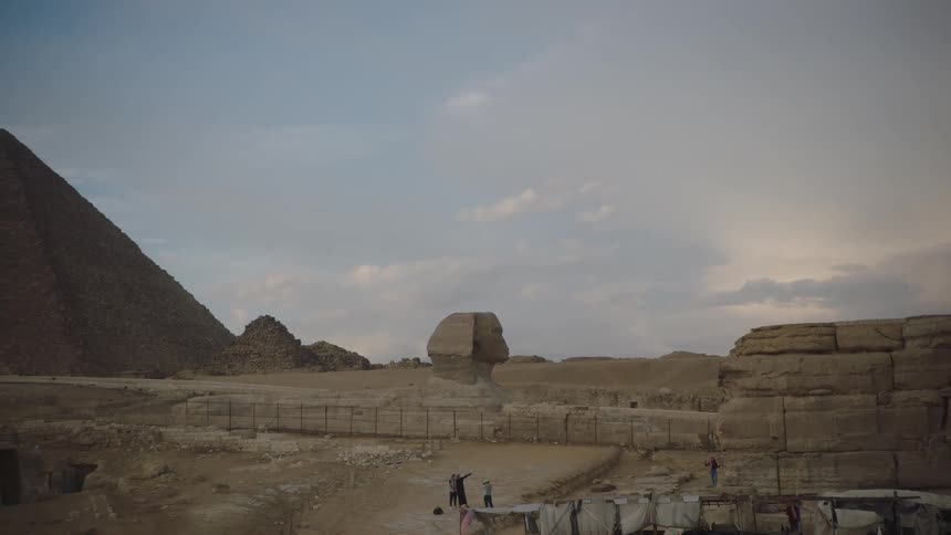 A slow pan reveals the majestic Great Pyramid of Giza and the Sphinx standing in the Egyptian desert