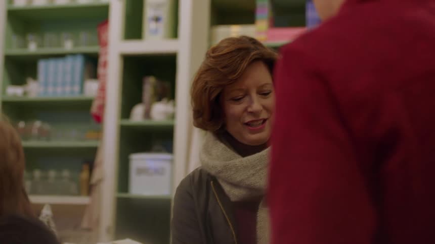 A family browses items in a christmas shop