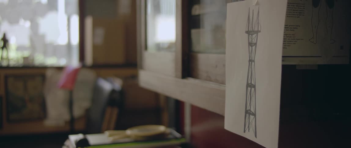 Close up of a drawing taped to a glass cabinet door