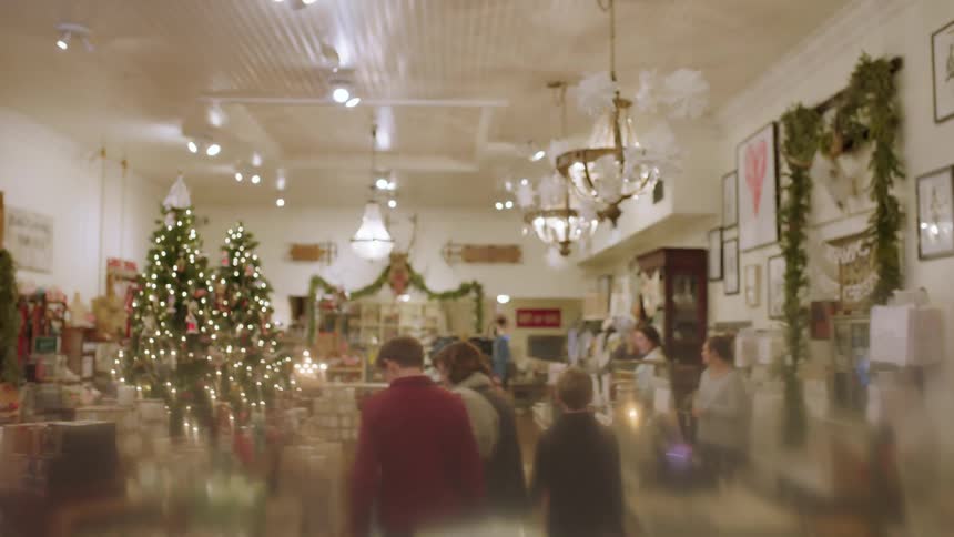 A family walks around a store decorated for christmas