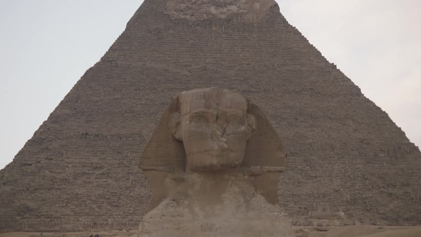 A tilt-down shot reveals the iconic Great Sphinx of Giza standing guard before the Pyramid of Khafre