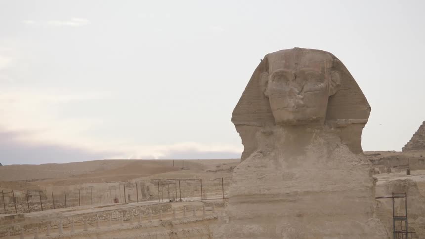 A medium shot of the ancient Great Sphinx of Giza monument in the Egyptian desert