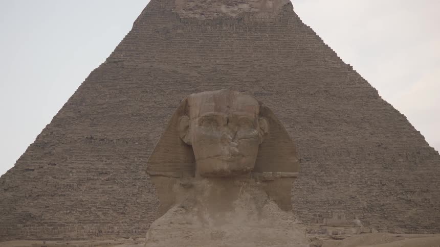 The ancient Great Sphinx stands guard before the Pyramid of Khafre on the Giza plateau in Egypt