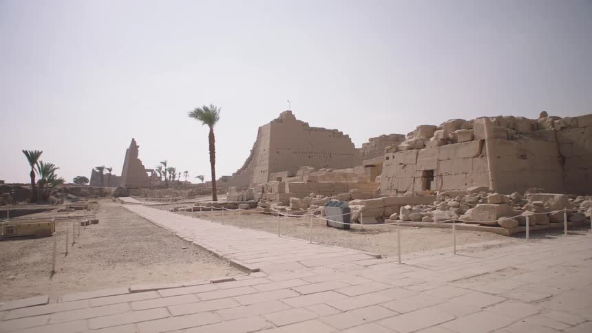 Slowly advancing towards the magnificent ancient ruins of the Karnak Temple in Luxor, Egypt, on a hot desert day