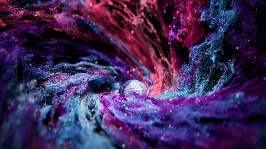 A futuristic metallic soccer ball sits at the heart of a mesmerizing, swirling cosmic nebula of colorful gas and glittering stardust