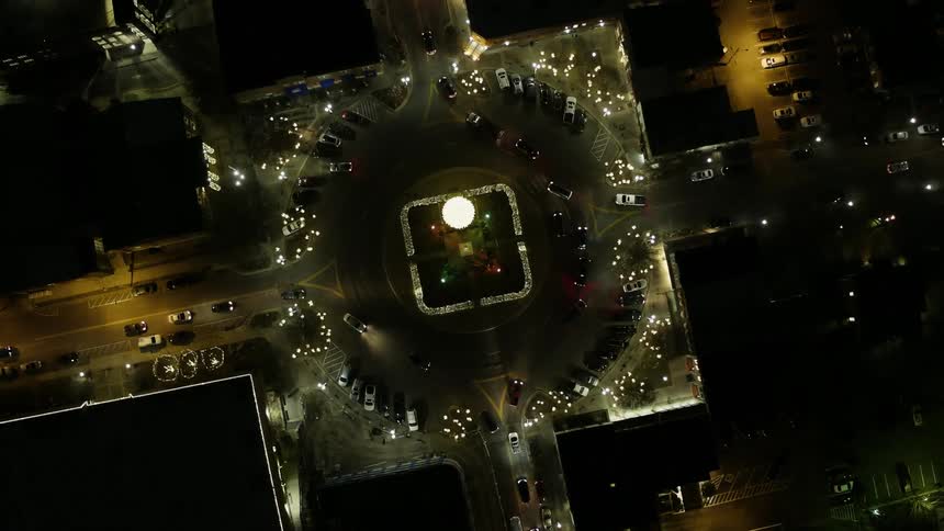 Vehicles travel around the town square below