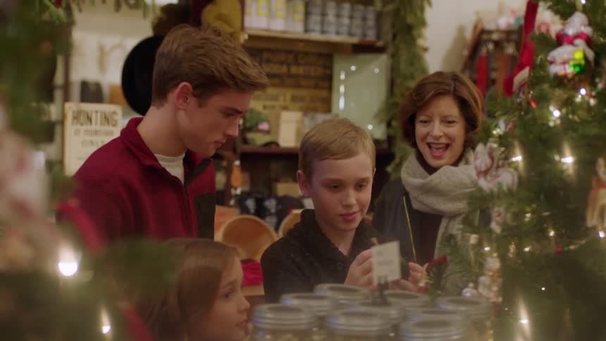 A family look at items in a shop and talk