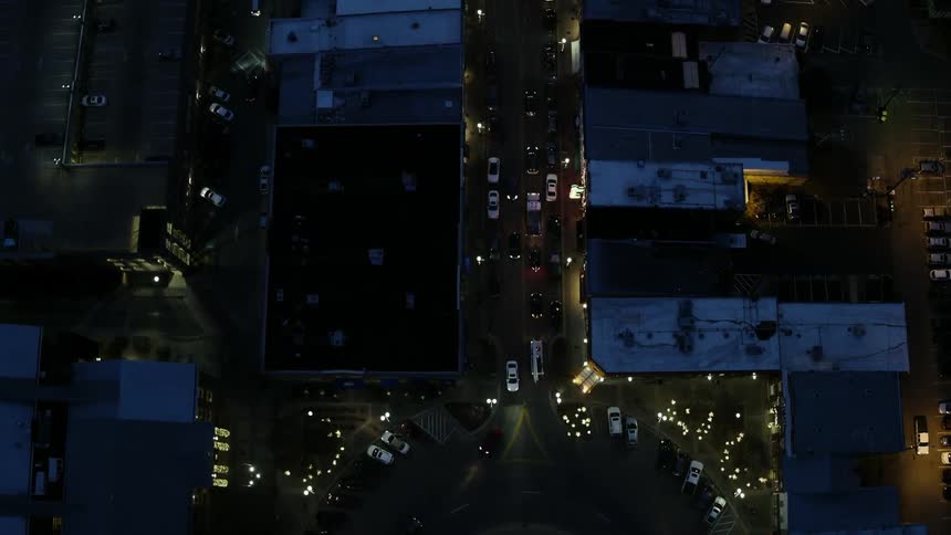 Cars drive down the roads of this town at night