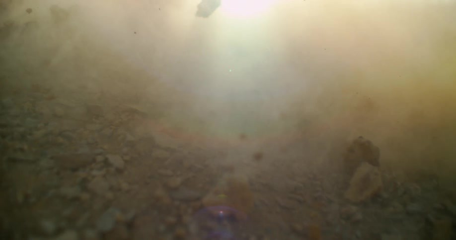 Dirt and rocks rolling and tumbling on the ground