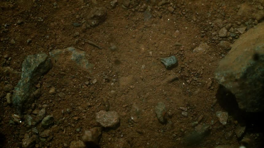 Rocks and dirt rolling and tumbling across the ground
