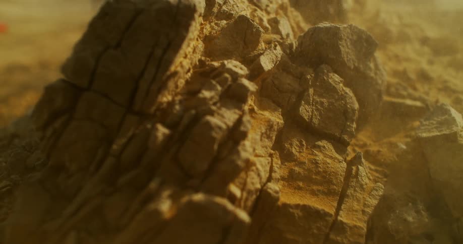 Dust swirls around rock on the ground