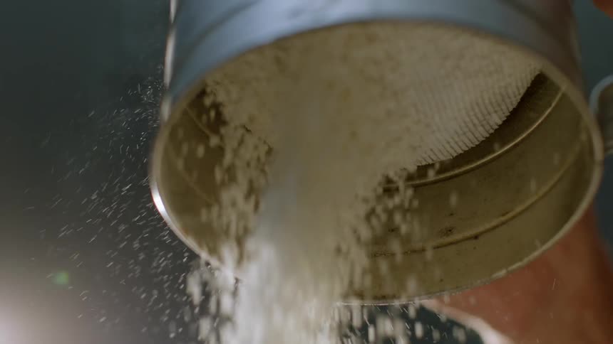 Powdered sugar falls from a container