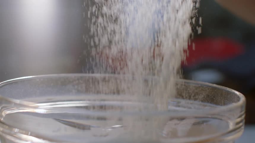 Powdered sugar is poured into a bowl