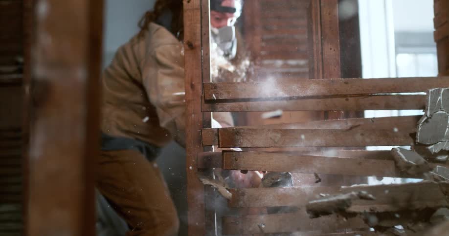 Interior demolition of a home shows a plaster and lath wall exploding in super slow motion