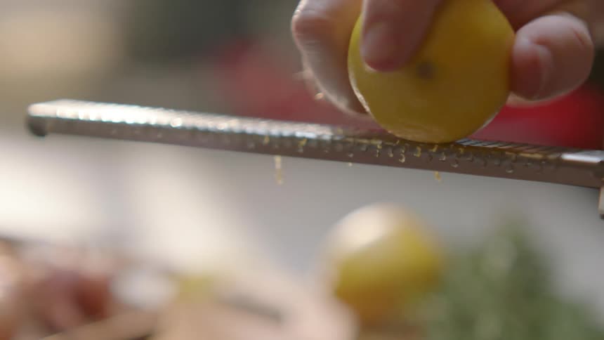 Person grating a lemon