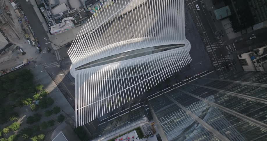A dramatic aerial top-down view pulls up to reveal the iconic architecture of the Oculus at the World Trade Center in New York City