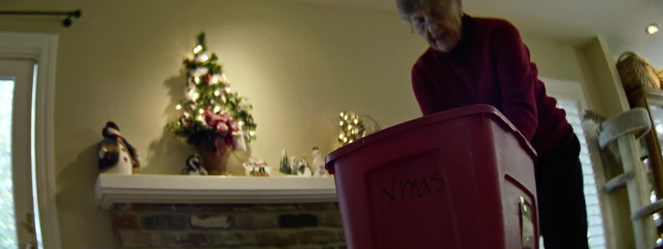 A woman removes ornaments from the chimney