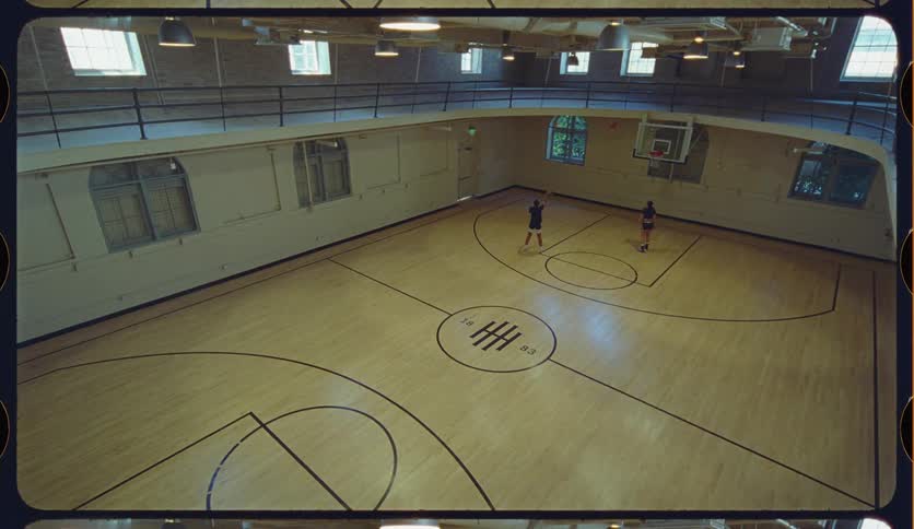 High angle view of two friends practicing their basketball skills on a unique and stylish indoor court