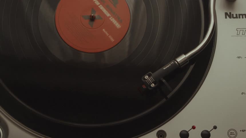 A top-down, close-up view shows a classic Frank Sinatra vinyl record spinning on a turntable
