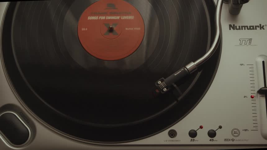 A close-up, top-down view of a classic Frank Sinatra vinyl record spinning on a turntable