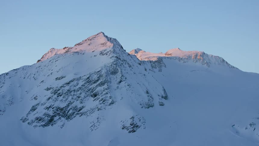 A zooming in view slowly of an ice covered mountain