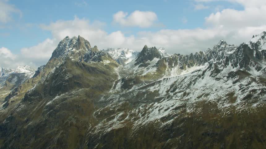 Blue sky above jagged mountain peaks