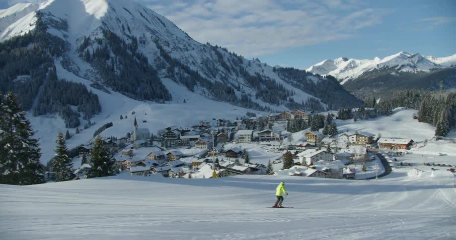A person is skiing on a long slope
