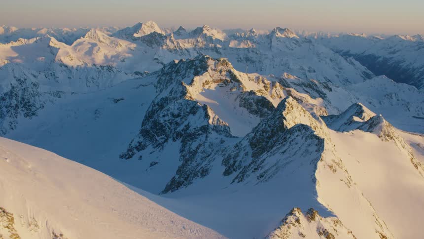 Snow covers the peaks and valleys of a mountain range