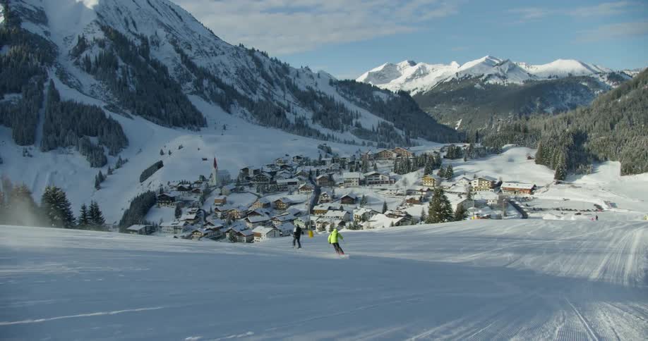 Person skiing down snow slope at mountain ski resort