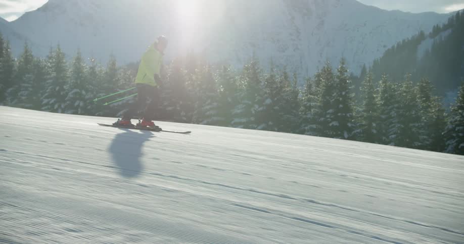 A person is skiing on a slope on a sunny day