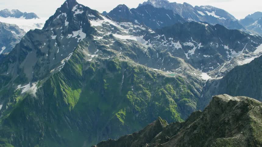Rocky mountains are shown with snow on the peaks