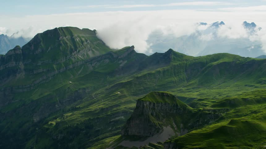Mountains covered in green grass on cloudy day