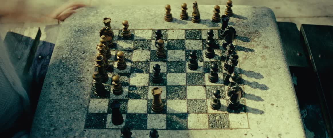A fast-paced time-lapse of a chess game played on a rustic stone board outdoors