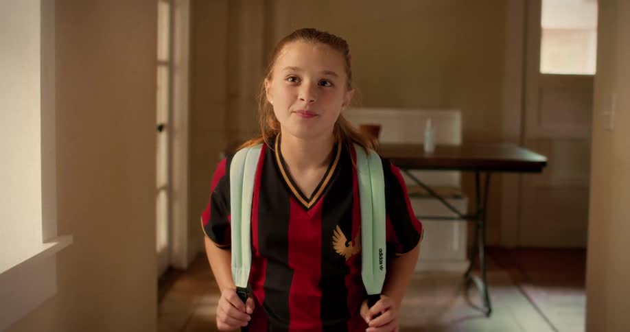 Portrait of a proud young female soccer player smiling and ready for school or practice